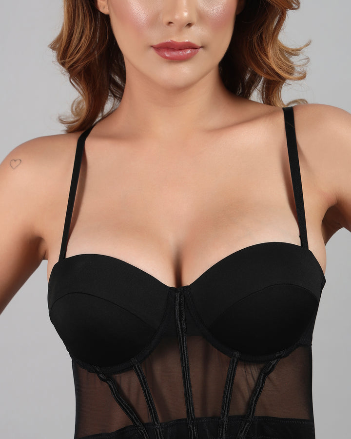 Black strapless top worn by a model on a plain background